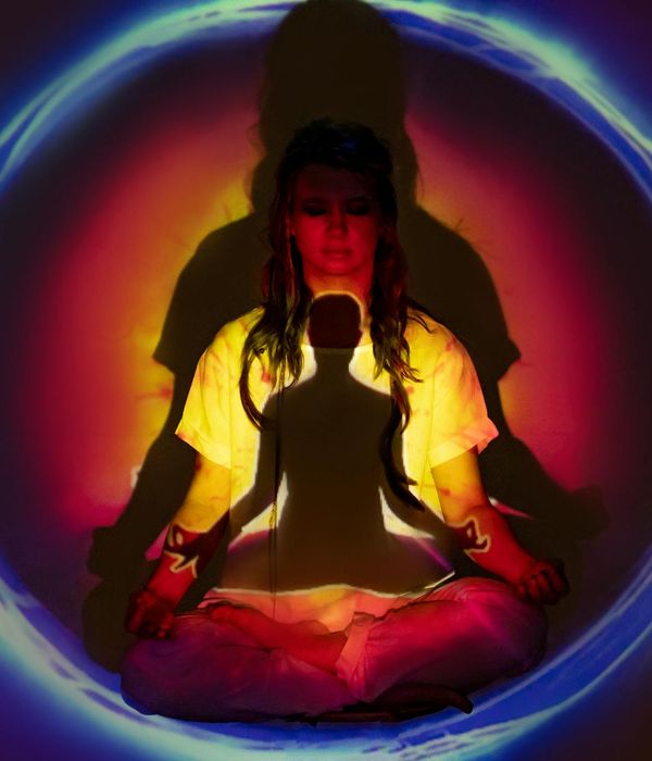 Woman in a flowing yoga pose with a look of peaceful concentration.